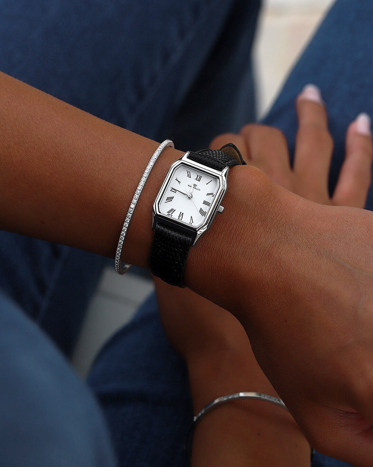 A square womens watch in Rhodium-plated 316L stainless steel with a black genuine leather strap from Waldor & Co. with white Diamond Cut Sapphire Crystal glass dial. Seiko movement. The model is Eternal 22 Varenna.