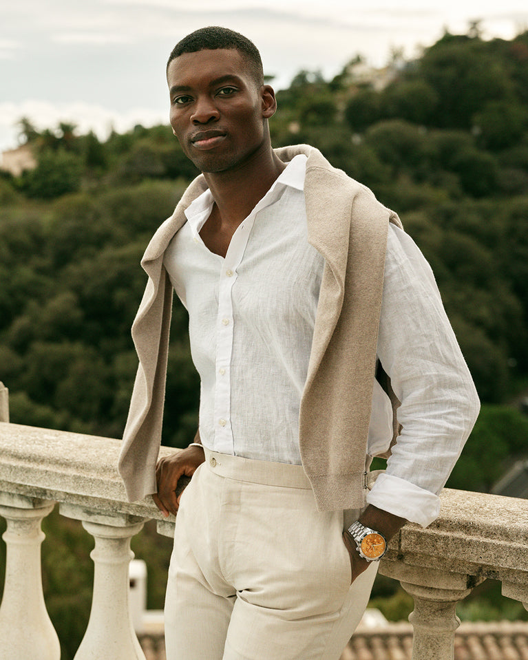 A round mens watch in rhodium-plated silver from Waldor & Co. with orange sunray dial and a second hand. Seiko movement. The model is Chrono 44 Como 44mm.
