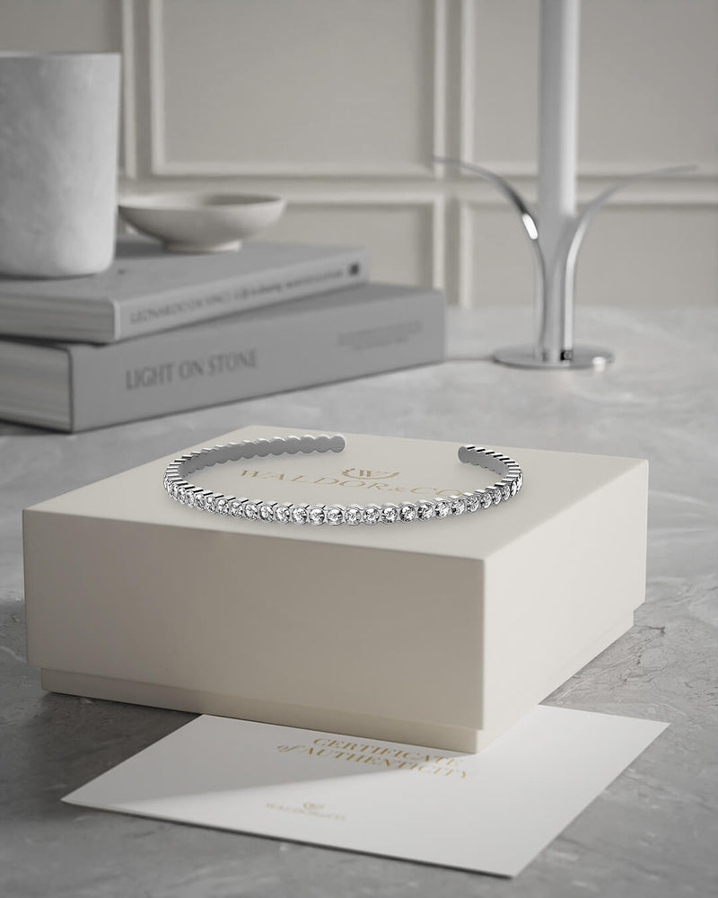 Bangle in Rhodium-plated 316L stainless steel from Waldor & Co. One size. The model is Grace Bangle Polished.