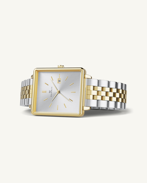 A square womens watch in silver and 14k gold from Waldor & Co. with silver sunray dial and a second hand. Seiko movement. The model is Delight 32 Chelsea 28x32mm.