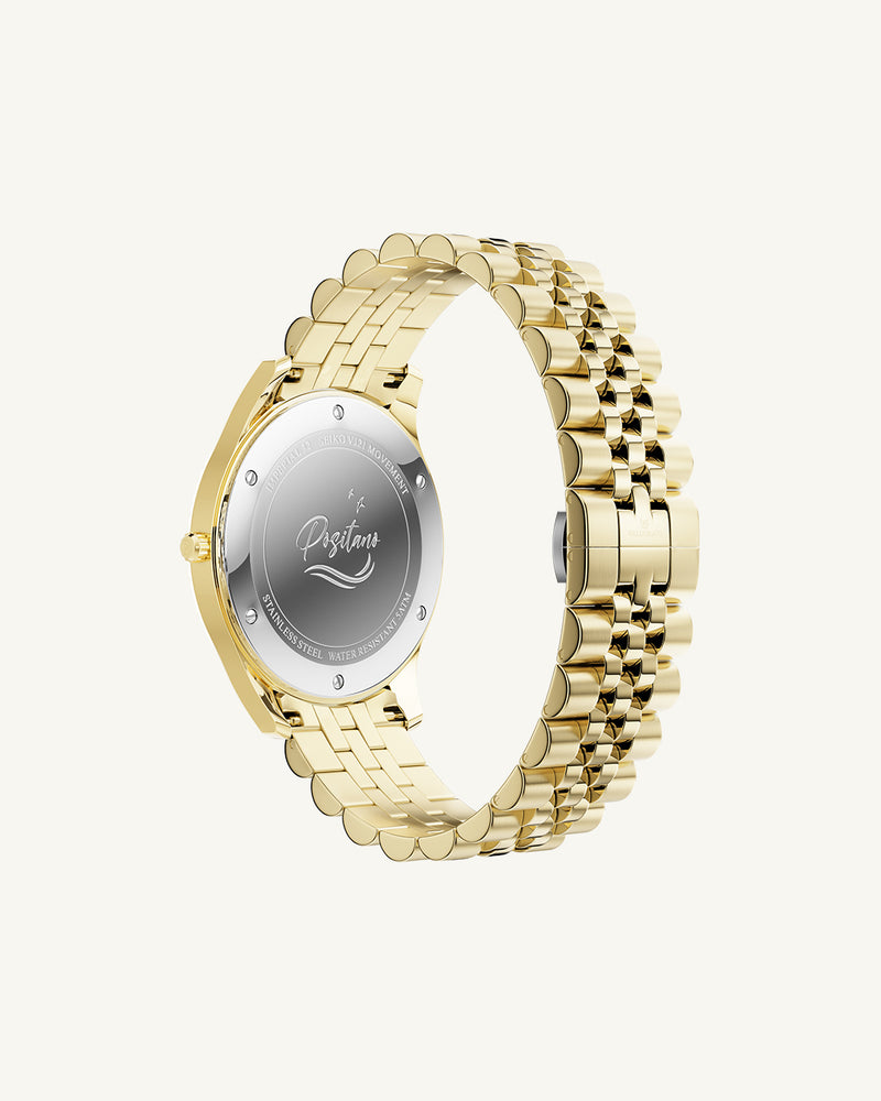 A round womens watch in 14k gold from Waldor & Co. with white sunray dial and a second hand. Seiko movement. The model is Imperial 32 Positano 32mm.