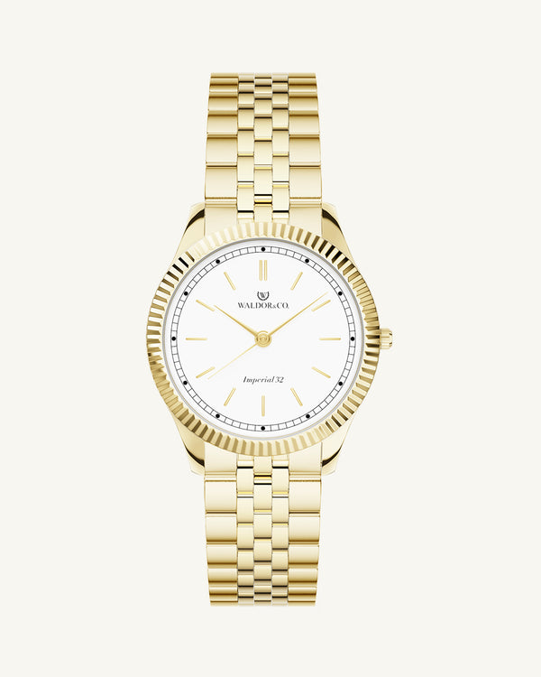 A round womens watch in 14k gold from Waldor & Co. with white sunray dial and a second hand. Seiko movement. The model is Imperial 32 Positano 32mm.